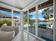 Bright living room with sliding glass doors offering scenic waterfront views at 3455 Winding Oaks Dr # 28, Longboat Key, FL 34228