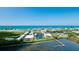 Aerial view of condo community near the ocean, showing buildings and landscaping at 3705 E Bay Dr # 212, Holmes Beach, FL 34217