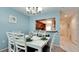 Bright dining room with white table and chairs, kitchen view at 3705 E Bay Dr # 212, Holmes Beach, FL 34217