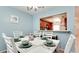 Dining area with white table and chairs, kitchen view at 3705 E Bay Dr # 212, Holmes Beach, FL 34217