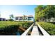 Building exterior showing walkway leading to condo building with lush landscaping at 3705 E Bay Dr # 212, Holmes Beach, FL 34217