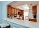 Kitchen features light wood cabinets, a tile backsplash, and breakfast bar at 3705 E Bay Dr # 212, Holmes Beach, FL 34217