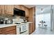 Bright kitchen with wood cabinets, tiled backsplash, and modern appliances at 3705 E Bay Dr # 212, Holmes Beach, FL 34217