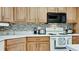Modern kitchen with wood cabinets and a tile backsplash at 3705 E Bay Dr # 212, Holmes Beach, FL 34217