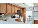 Kitchen boasts wood cabinets, tile backsplash, and ample counter space at 3705 E Bay Dr # 212, Holmes Beach, FL 34217