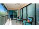 Relaxing lanai with wicker chairs and peaceful views at 3705 E Bay Dr # 212, Holmes Beach, FL 34217