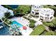 Community pool with surrounding lounge chairs and patio area at 3705 E Bay Dr # 212, Holmes Beach, FL 34217