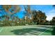 Well-maintained tennis court surrounded by lush greenery at 3705 E Bay Dr # 212, Holmes Beach, FL 34217