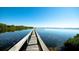 Serene waterfront view with a wooden dock extending into the water at 3705 E Bay Dr # 212, Holmes Beach, FL 34217