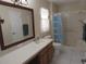 Clean bathroom with shower/tub combo and wood vanity at 3920 Douglas Hill Pl, Parrish, FL 34219