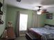 Guest bedroom with wood-framed bed and window at 3920 Douglas Hill Pl, Parrish, FL 34219