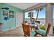 Bright dining room with water views, a glass table and wicker chairs at 4430 Exeter Dr # 103, Longboat Key, FL 34228