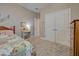 Cozy bedroom with a charming patchwork quilt and built-in shelving at 451 Daylily Blvd, Nokomis, FL 34275