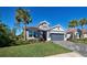 Single-story home with gray exterior, tile roof, and landscaped yard at 451 Daylily Blvd, Nokomis, FL 34275