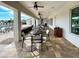 Covered patio area by the pool with tables, chairs, and ceiling fans at 451 Daylily Blvd, Nokomis, FL 34275