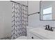 Modern bathroom with patterned shower curtain and pebble floor at 5025 Bell Meade Dr, Sarasota, FL 34232