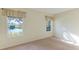 Well-lit bedroom with carpet and a view of the lake at 5032 Newport News Cir, Bradenton, FL 34211