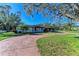 Ranch style home with circular driveway and mature landscaping at 5120 33Rd E St, Bradenton, FL 34203