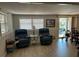 Bright living room with two recliners and wood-look floors at 5151 Pebble Beach Ave, Sarasota, FL 34234