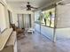 Relaxing screened porch with tiled floor, ceiling fan, and view of backyard at 5277 San Luis Ter, North Port, FL 34286