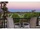Balcony with seating overlooking a golf course and city view at sunset at 545 Sanctuary Dr # B406, Longboat Key, FL 34228