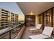 Balcony with lounge chairs offering stunning sunrise and ocean views at 545 Sanctuary Dr # B406, Longboat Key, FL 34228