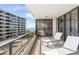 Balcony with lounge chairs and a partial ocean view at 545 Sanctuary Dr # B406, Longboat Key, FL 34228