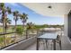 Balcony with a dining table and golf course views at 545 Sanctuary Dr # B406, Longboat Key, FL 34228