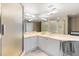 Bathroom featuring a white vanity, frosted glass shower doors, and marble flooring at 545 Sanctuary Dr # B406, Longboat Key, FL 34228