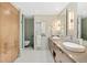 Modern bathroom with double sinks, wood cabinetry, and tiled floors at 545 Sanctuary Dr # B406, Longboat Key, FL 34228