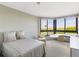 Guest bedroom with a bed, a desk, large windows and scenic views at 545 Sanctuary Dr # B406, Longboat Key, FL 34228