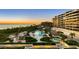 Resort pool area at sunset with ocean views at 545 Sanctuary Dr # B406, Longboat Key, FL 34228