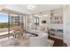 Cozy den/office with built-in bookshelves and comfortable seating at 545 Sanctuary Dr # B406, Longboat Key, FL 34228