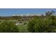 Lush green golf course surrounded by trees and cityscape at 545 Sanctuary Dr # B406, Longboat Key, FL 34228