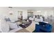 Living area with white furniture and a stylish rug, open to the dining area at 545 Sanctuary Dr # B406, Longboat Key, FL 34228