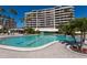 Large pool with ample space for lounging and swimming, surrounded by palm trees at 545 Sanctuary Dr # B406, Longboat Key, FL 34228