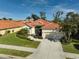 Aerial view of single-Gathering house, landscaping, and driveway at 567 Laurel Cherry Ln, Venice, FL 34293