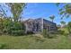 View of the home's backyard, showcasing a screened pool area at 567 Laurel Cherry Ln, Venice, FL 34293