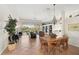 Bright dining room with a wooden table, chairs, and access to the kitchen and living areas at 567 Laurel Cherry Ln, Venice, FL 34293