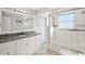 Updated bathroom with granite countertop, white cabinets, and a walk-in shower at 584 Beverly Rd, Venice, FL 34293