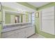 Bathroom boasts granite countertops and a large mirror at 584 Beverly Rd, Venice, FL 34293