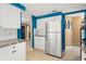 Modern kitchen with stainless steel refrigerator and ample storage at 584 Beverly Rd, Venice, FL 34293