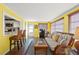 Living room features yellow walls, wicker furniture, and kitchen pass-through at 584 Beverly Rd, Venice, FL 34293