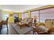 Relaxing sunroom with wicker furniture and bright yellow walls at 584 Beverly Rd, Venice, FL 34293