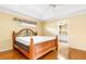 Spacious bedroom with wood floors and ensuite bathroom access at 6600 Deering Cir, Sarasota, FL 34240