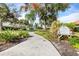 Paved pathway winds through lush landscaping, leading to community amenities at 6600 Deering Cir, Sarasota, FL 34240