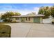 Tan single story home with green garage door and spacious driveway at 6915 11Th Nw Ave, Bradenton, FL 34209