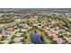 A panoramic aerial view of the community reveals a lush landscape, winding roads, serene ponds and a golf course at 7042 Twin Hills Ter, Lakewood Ranch, FL 34202