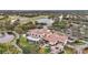 A grand clubhouse features a well-manicured landscape, a large parking area, and scenic golf course views at 7042 Twin Hills Ter, Lakewood Ranch, FL 34202