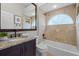 Bathroom featuring a tub and shower, granite countertop vanity, and neutral tile surround at 7042 Twin Hills Ter, Lakewood Ranch, FL 34202